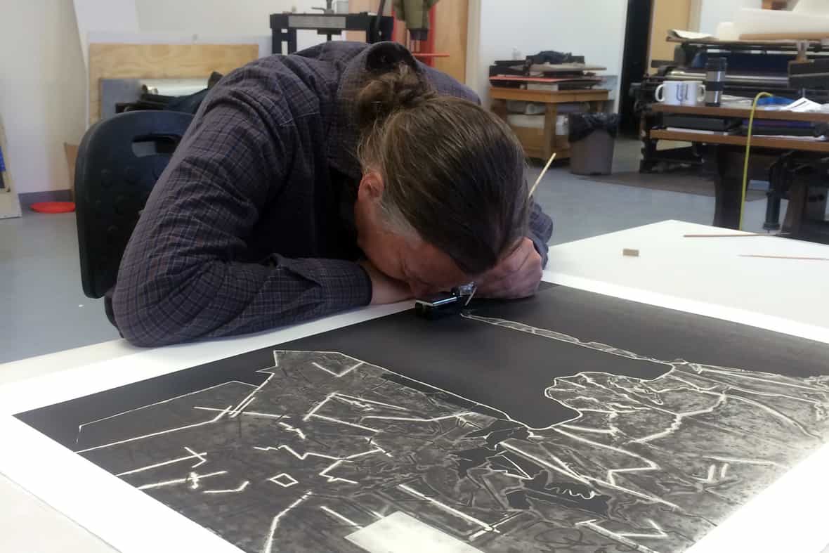 Bruce Wankel curating a sheet for Jasper John’s “Regrets,” 2014