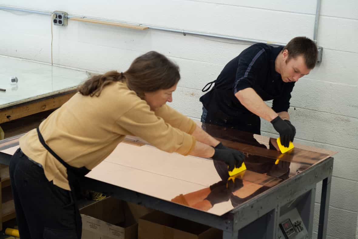 Bruce Wankel and Brian Berry inking an etching plate